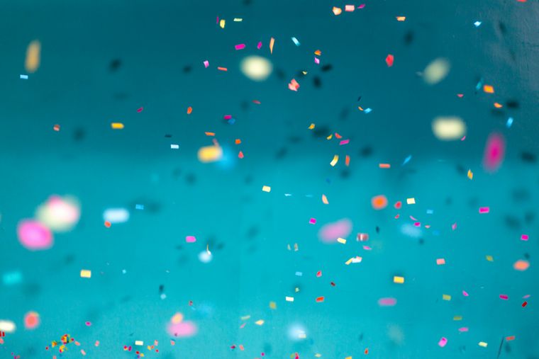 photo of colorful konfetti in front of a blue wall